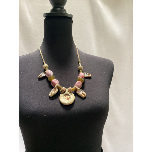 Necklace made of beads and ceramic pieces. Strung on rawhide