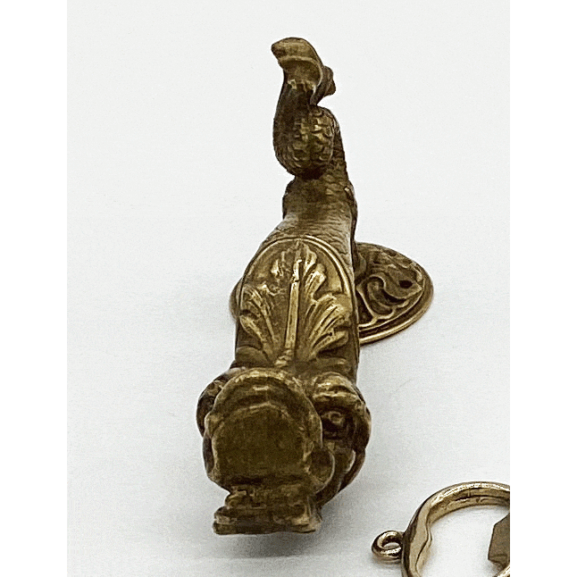 Antique brass door handle with image of a dolphin